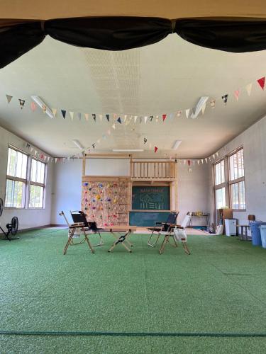 a large room with chairs and flags on the ceiling at Nagatanchi - Vacation STAY 19913v in Mimata