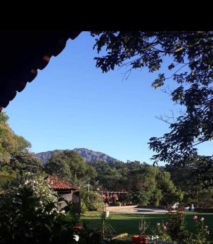 a view of a park with a mountain in the background at Quinta da Bela Vista in Caeté