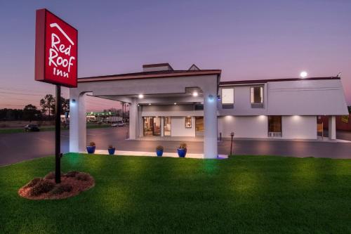 a sign in the grass in front of a house at Red Roof Inn Rocky Mount - Battleboro in Battleboro