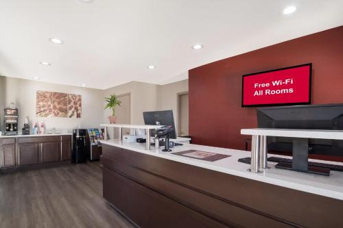 an office with a sign that reads free wifi all rooms at Red Roof Inn Rocky Mount - Battleboro in Battleboro