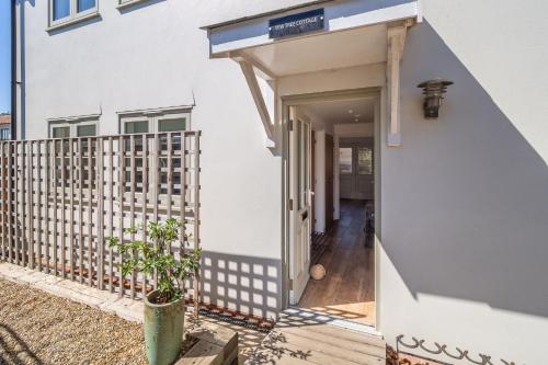 a house with a staircase leading to the front door at Yew Tree Cottage in Westleton