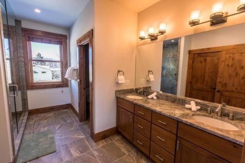 a bathroom with two sinks and a large mirror at Modern Mountain Lodge Oasis w Hot Tub-Rio Grande Trail in Carbondale
