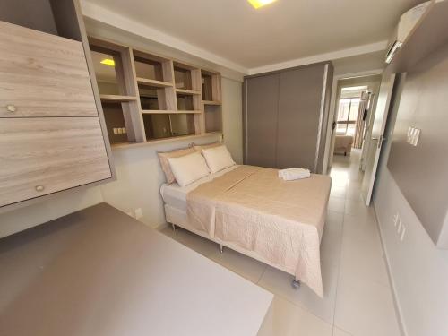 a small bedroom with a bed and a small cabinet at HOLANDAS PRIME TAMBAU Flat in João Pessoa