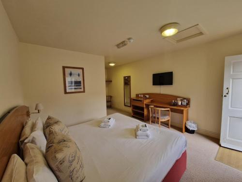 a hotel room with a bed and a desk at The Cherry Tree in Abingdon