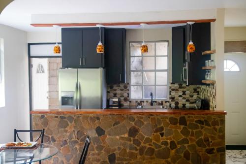 a kitchen with black cabinets and a stone counter top at Mountain View Vacation Home 