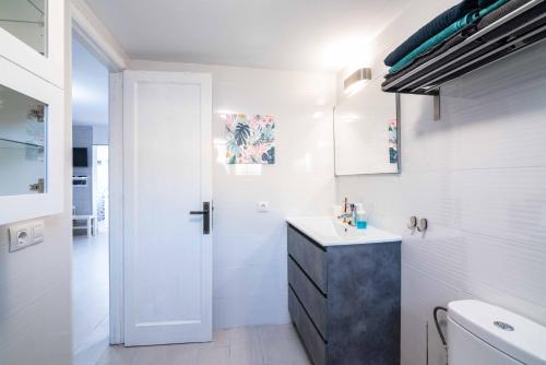 a white bathroom with a sink and a toilet at Casa Nina in Tías