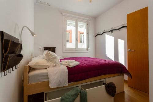 a bedroom with a bed with a purple blanket at Atico & Jacuzzi CRUZ by Cadiz4Rentals in Cádiz