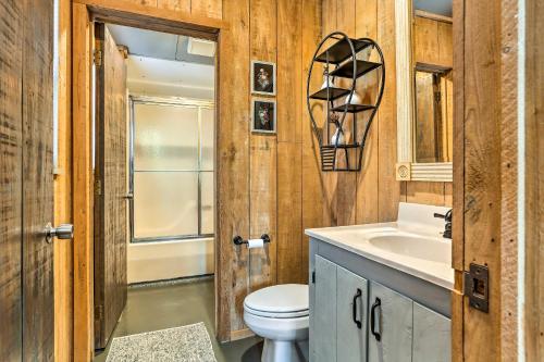 a bathroom with a toilet and a sink and a mirror at Cozy Hatteras Island Abode about 1 Mi to Frisco Beach! in Frisco