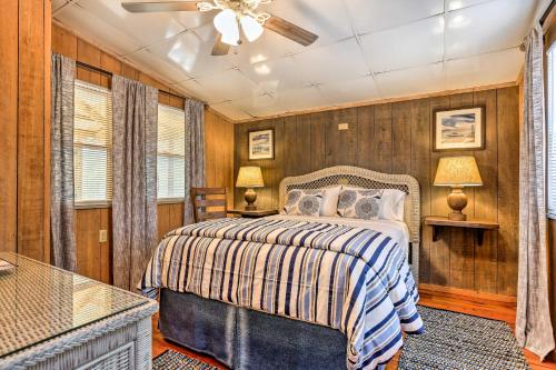 a bedroom with a bed and a ceiling fan at Cozy Hatteras Island Abode about 1 Mi to Frisco Beach! in Frisco