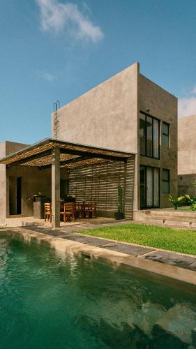 a house with a pool of water in front of it at Aldea Paraíso - Adults only - Boutique hotel in Puerto Escondido