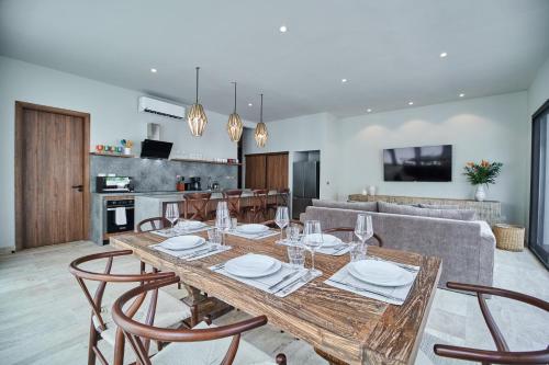 a dining room and kitchen with a table and chairs at Luxury Villa with 2 Pools, Open Terraces and Sun Deck in Tulum