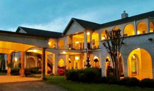 a large white building with lights on at Tennessee Room at Tennessee RiverPlace in Chattanooga