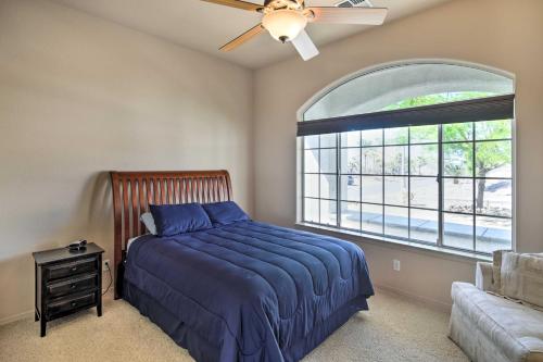a bedroom with a bed and a large window at Cozy Bullhead City Home with Patio and Mountain Views! in Bullhead City