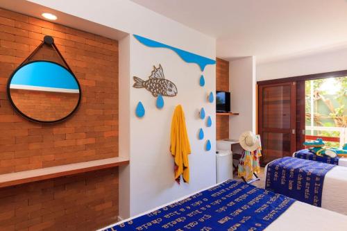 a bedroom with a mirror and a bed at Hotel Village Porto De Galinhas in Porto De Galinhas