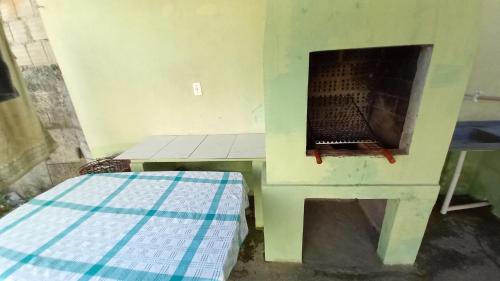 a room with a fireplace and a bed in it at Casa Temporada 400mts Praia Mariscal in Bombinhas