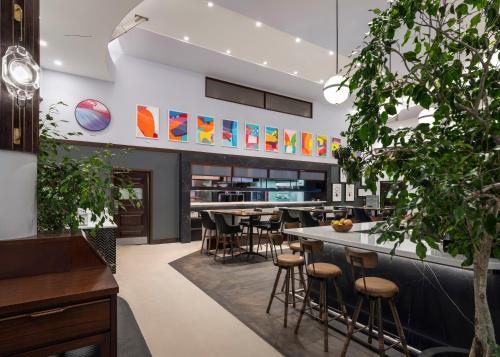 a restaurant with a bar with stools at Hamilton Princess & Beach Club A Fairmont Managed Hotel in Hamilton