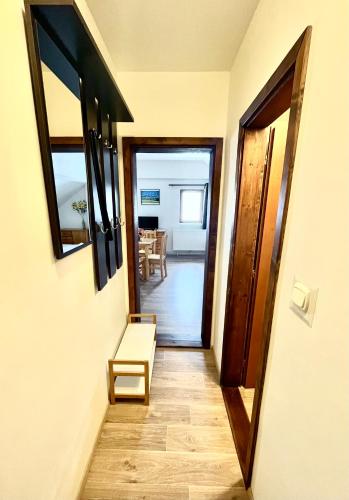 a hallway with a door and a chair and a table at Penzion Dolní Morava in Dolní Morava