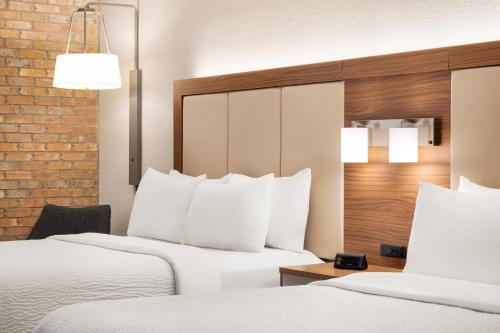 two beds in a hotel room with white pillows at Holiday Inn Express - San Antonio Airport by IHG in San Antonio