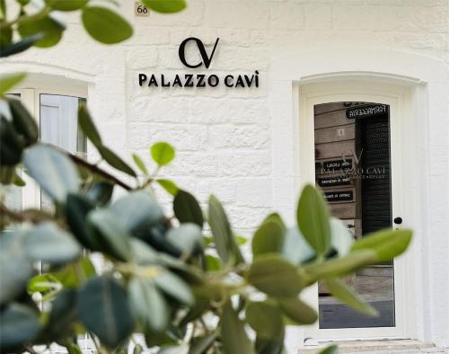 a building with a door and a sign on it at PALAZZO CAVÌ in Mola di Bari