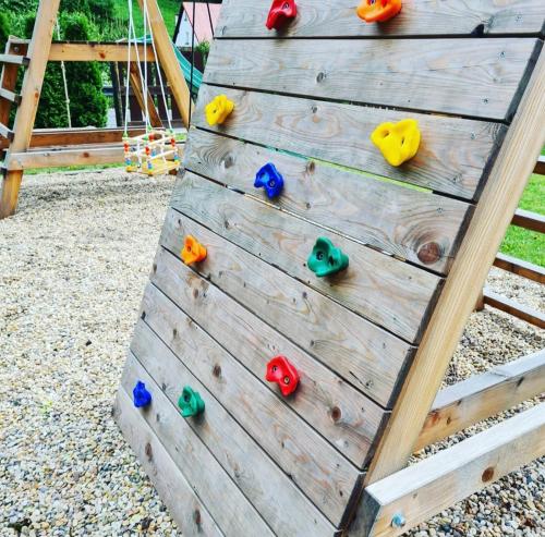 a wooden climbing wall in a playground at Apartmány Černý Důl in Cerny Dul