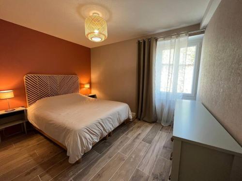 a bedroom with a white bed and a window at Charmant logement à Sancerre in Sancerre