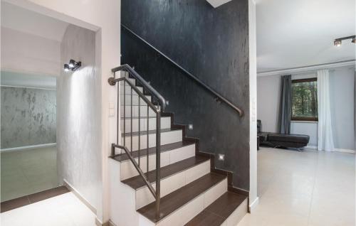 a staircase in a house with a black wall at 8 Bedroom Awesome Home In Kamien in Kamień