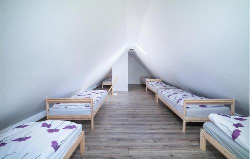 a row of beds in a room with a attic at 8 Bedroom Awesome Home In Kamien in Kamień
