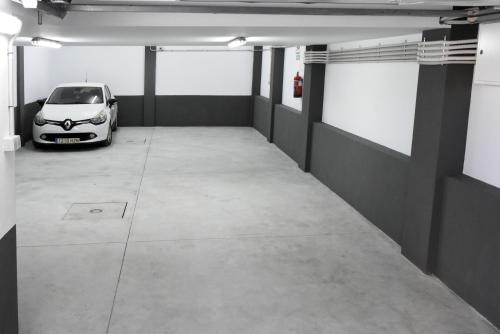 a parking garage with a car parked in it at APTOS MILLÁN in Ardales