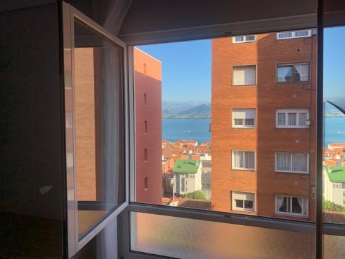 a window with a view of a building at Apartamento Santander in Santander