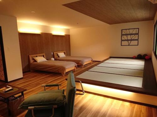 Habitación con 2 camas, sofá y mesa. en Mari Beauty Salon 2F - Vacation STAY 16557v en Sado