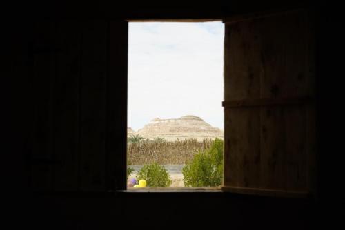 a window with a view of a mountain at Barahsiwa in Siwa