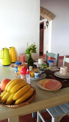 a table with bananas and other food on it at Barbanera Club & Hotel de Charme in Caucaia