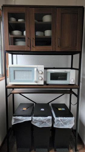 a kitchen shelf with two microwaves and a microwave at Annex Kanazawa - Vacation STAY 31114v in Kanazawa