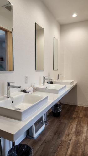 a bathroom with two sinks and two mirrors at Annex Kanazawa - Vacation STAY 31114v in Kanazawa
