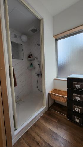 a walk in shower in a bathroom with a window at Annex Kanazawa - Vacation STAY 31114v in Kanazawa