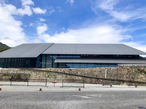 a building with a metal roof on the side of a road at Hotel Tsushima - Vacation STAY 64041v in Tsushima