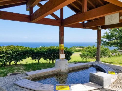 a swimming pool in a pavilion with the ocean in the background at Hotel Tsushima - Vacation STAY 84601v in Tsushima