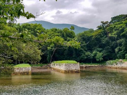 a river with two stone walls in the water at Hotel Tsushima - Vacation STAY 84601v in Tsushima