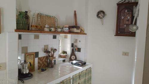 a kitchen with a counter with a shelf and a counter top at Majella National Park La Casa Di Nonna Maria in Caramanico Terme