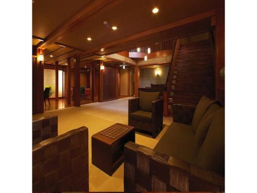 a living room with a couch and a chair at Manzatei - Vacation STAY 27688v in Ogushi