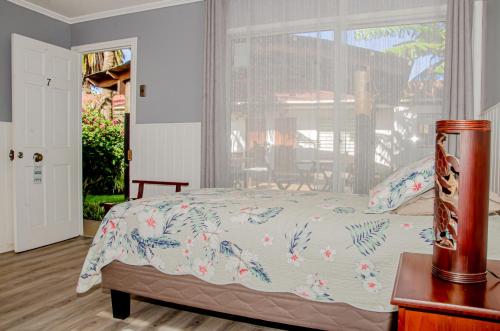 a bedroom with a bed and a table and a window at Inaki Uhi Hotel in Hanga Roa