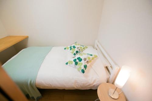 una camera con un letto con due cuscini sopra di Tokai Ryokan Ichigokan - Vacation STAY 29187v ad Atami