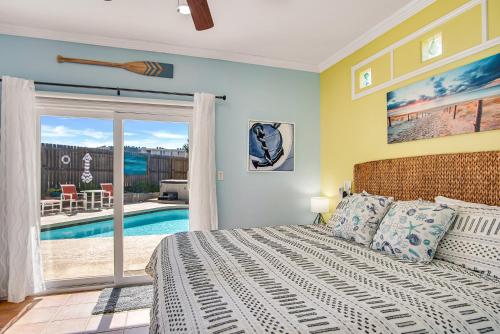 a bedroom with a bed and a pool at LaJuana Iguana - House in Port Aransas