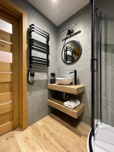 a bathroom with a sink and a shower at Domki przy skwerku in Zakopane