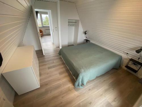 ein Schlafzimmer mit einem Bett in einem kleinen Zimmer in der Unterkunft Ferienhaus Karlsson mit Blick auf die Ostsee in Hohenfelde