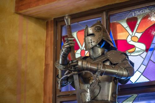 a metal robot in front of a stained glass window at Pytloun Old Armoury Hotel Prague, Stará Zbrojnice in Prague
