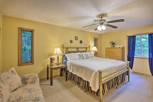 a bedroom with a bed and a ceiling fan at Arrowhead Lake Home with Game Room and Beach Access! in Pocono Lake