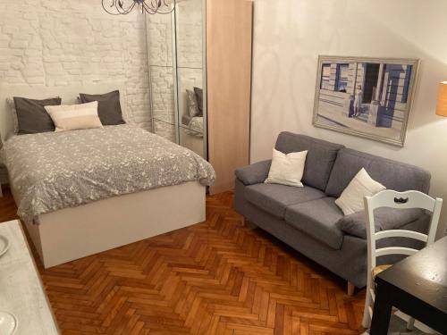 a living room with a bed and a couch at Bianka Apartment in Zagreb