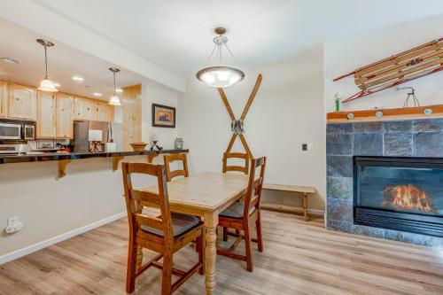 a kitchen and dining room with a table and chairs and a fireplace at Tavern Inn #39 in Olympic Valley