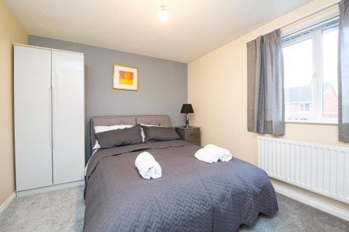 a bedroom with a bed with two towels on it at Durham Home Away from Home in Durham
